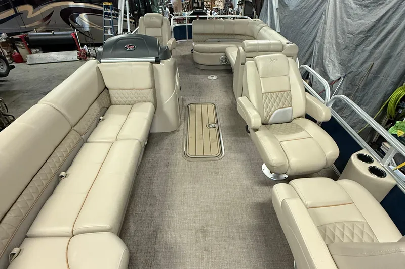 Slide: The Image of 2021 Ranger 223FC pontoon boat interior with beige seating and steering console. - 7