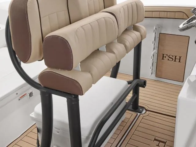 Slide: The Image of 2025 Yamaha Boats 255 FSH Sport E interior with beige seating and teak-style flooring. - 8