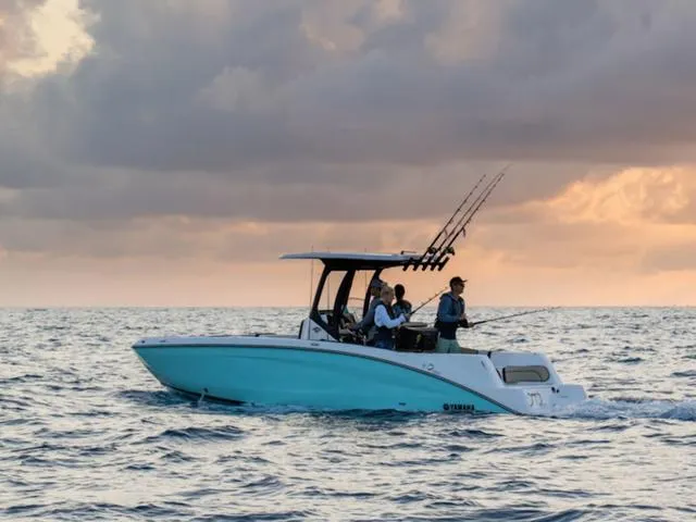 Slide: The Image of 2025 Yamaha Boats 255 FSH Sport E on ocean at sunset, with fishing rods. - 4