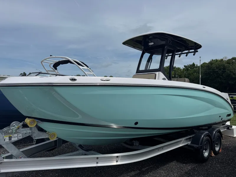 The Image of 2025 Yamaha Boats 255 FSH Sport E in light blue on trailer. - 0
