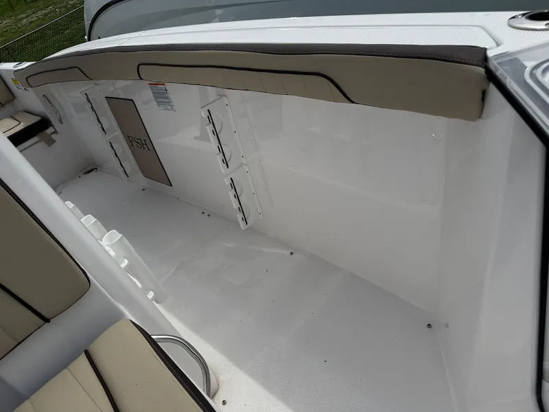 Slide: The Image of 2025 Yamaha Boats 255 FSH Sport E interior seating and storage area. - 12