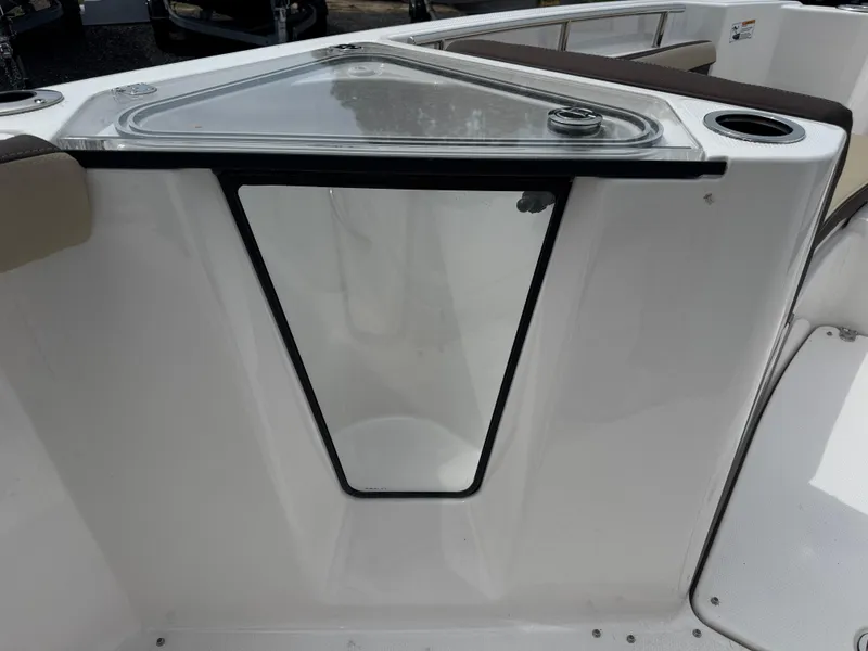 Slide: The Image of 2025 Yamaha Boats 255 FSH Sport E, bow storage compartment with transparent lid and cup holder. - 13