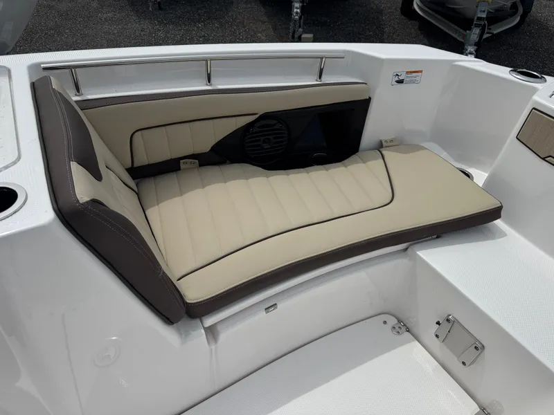 Slide: The Image of 2025 Yamaha Boats 255 FSH Sport E interior with beige cushioned seating. - 17