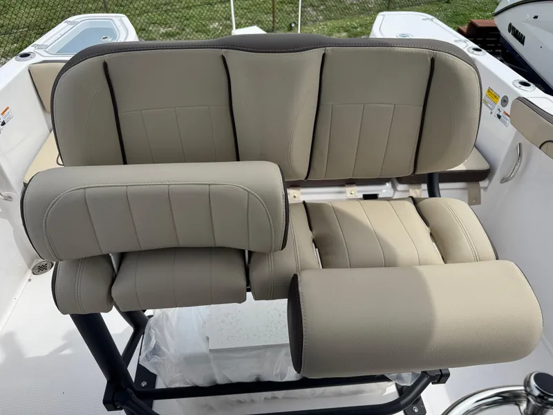 Slide: The Image of 2025 Yamaha Boats 255 FSH Sport E seating, featuring beige cushioned seats and armrests. - 22