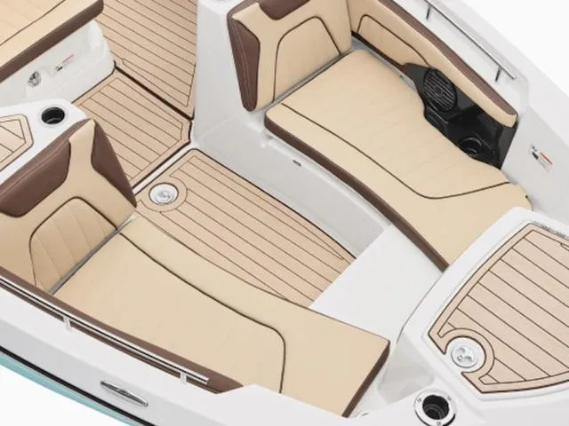 Slide: The Image of 2025 Yamaha Boats 255 FSH Sport E interior with beige and brown seating, sleek design. - 29