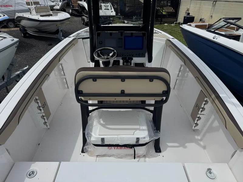 Slide: The Image of 2025 Yamaha Boats 255 FSH Sport E interior with helm and seating. - 4
