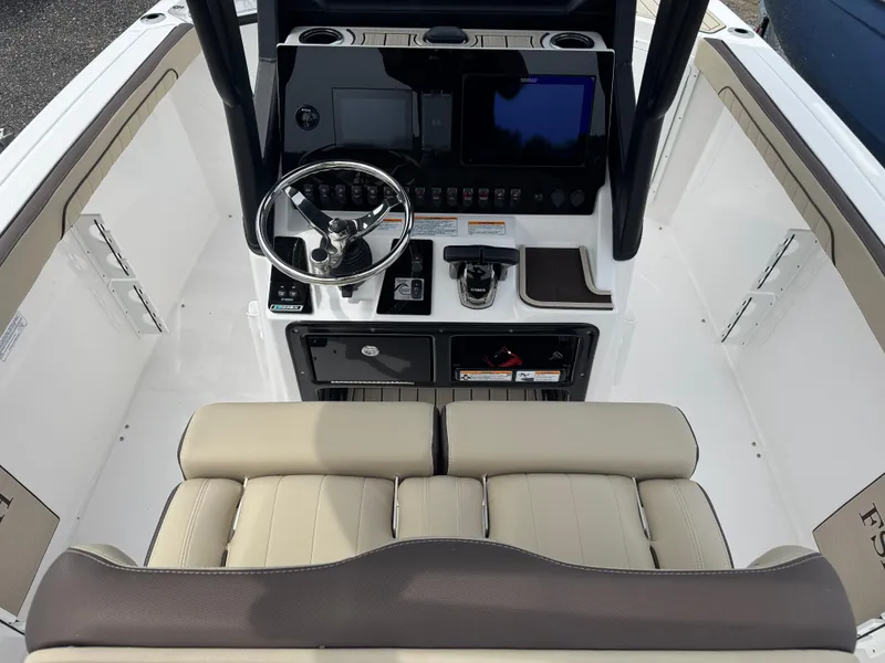 Slide: The Image of 2025 Yamaha Boats 255 FSH Sport E helm with steering wheel and controls. - 5