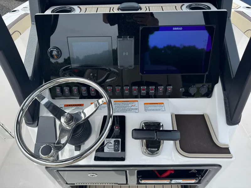 Slide: The Image of 2025 Yamaha Boats 255 FSH Sport E dashboard with steering wheel and controls. - 6