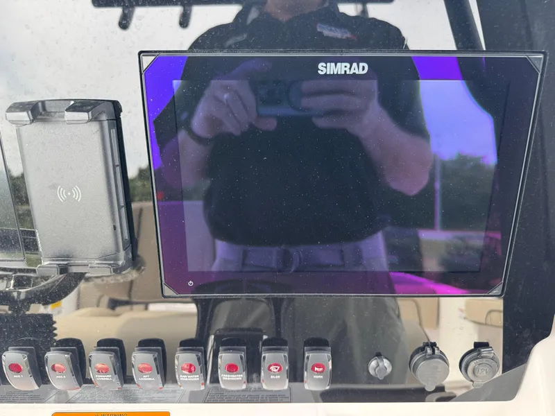 Slide: The Image of Control panel of 2025 Yamaha Boats 255 FSH Sport E with Simrad display. - 7
