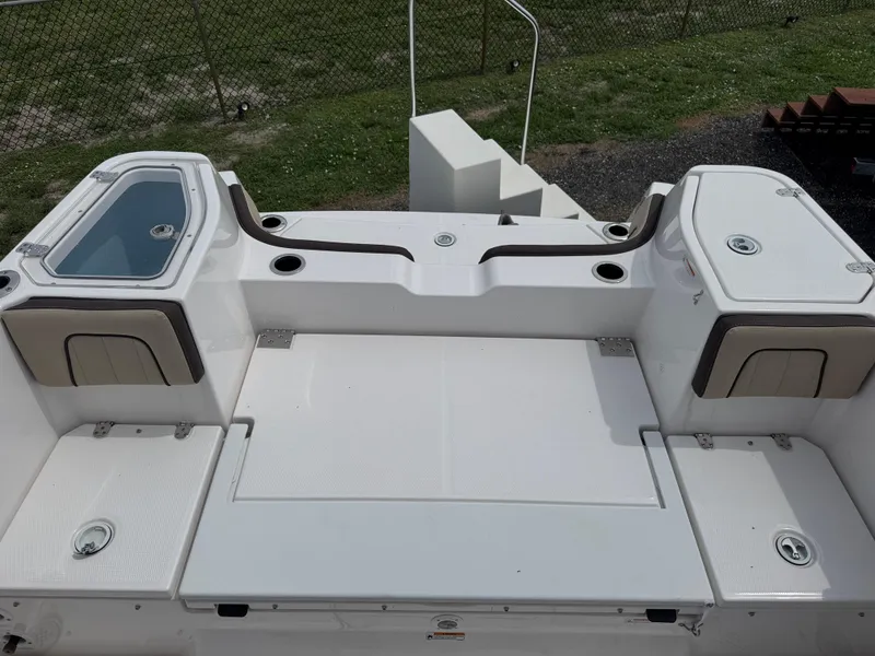 Slide: The Image of 2025 Yamaha Boats 255 FSH Sport E deck with storage compartments and seating. - 9