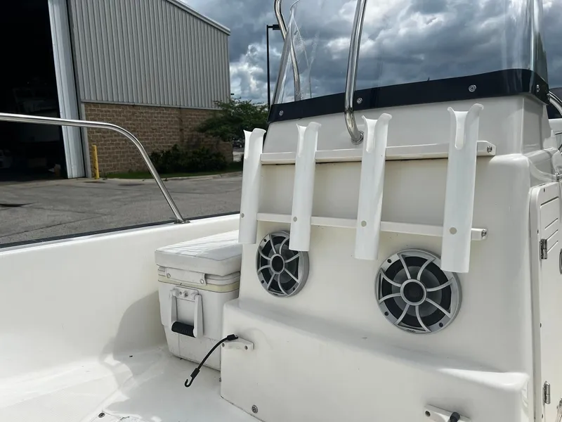 Slide: The Image of 2016 Boston Whaler 150 Montauk boat interior with rod holders and speakers. - 14
