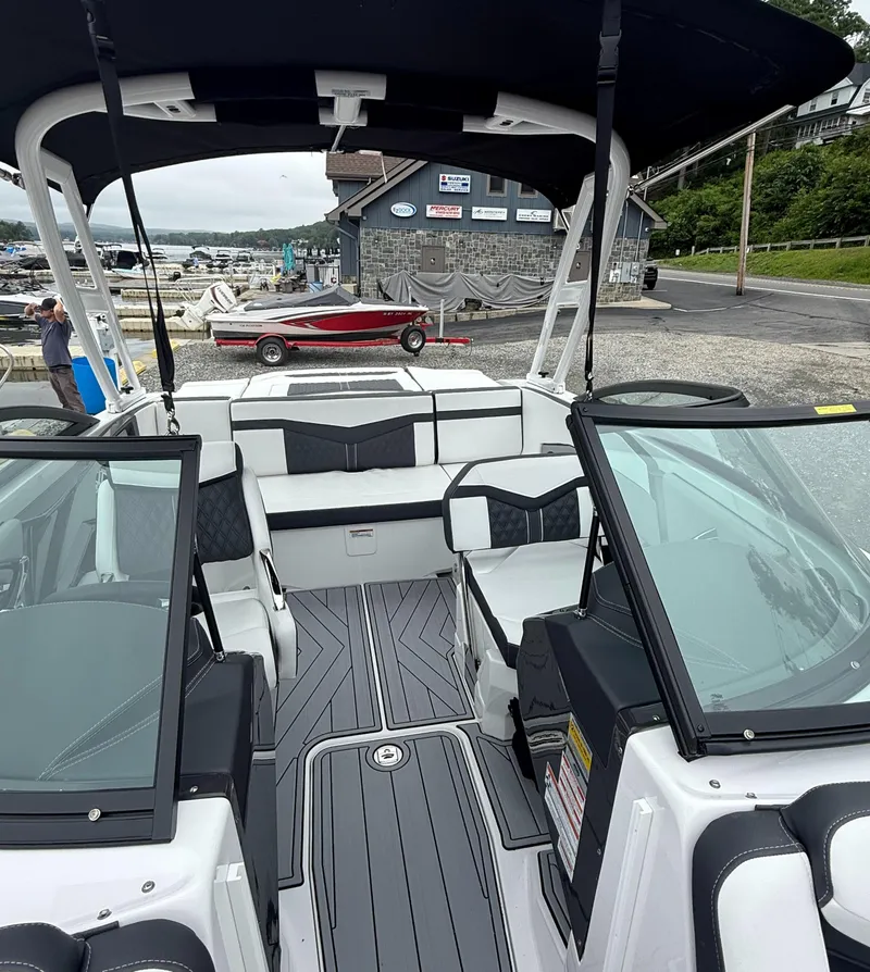 Slide: The Image of 2025 Monterey 238 Super Sport boat interior at marina, featuring sleek seating and modern design. - 6
