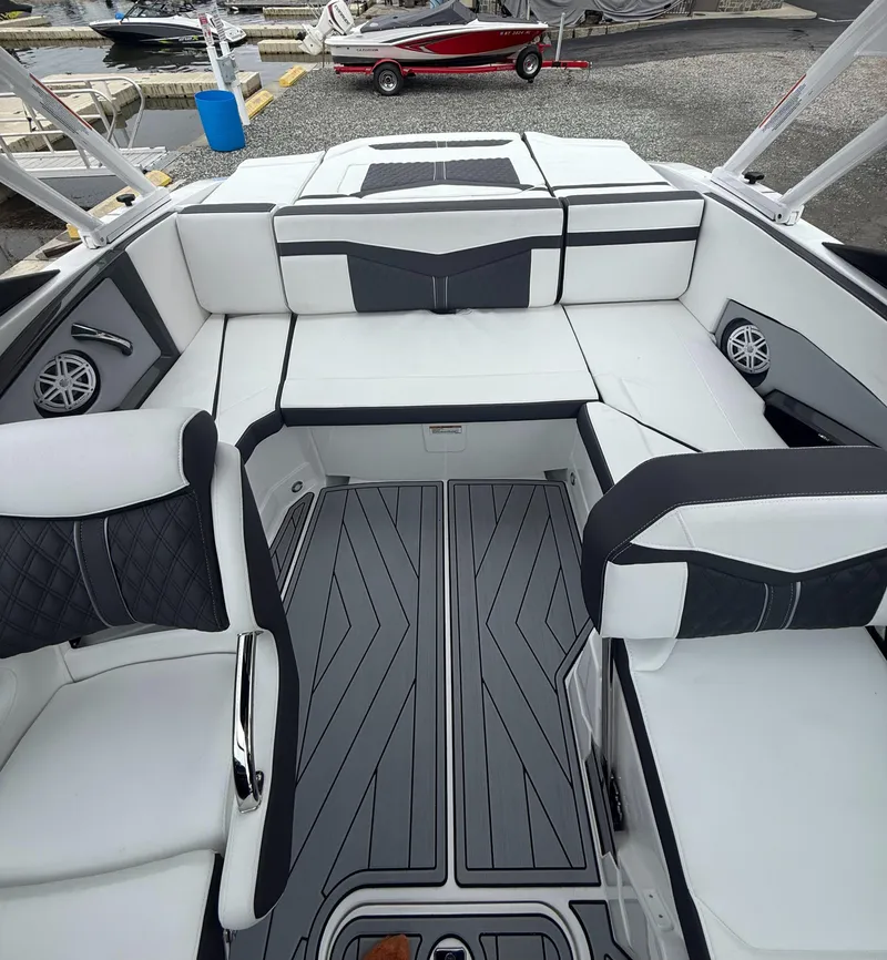 Slide: The Image of 2025 Monterey 238 Super Sport boat interior with sleek white and black seating. - 8