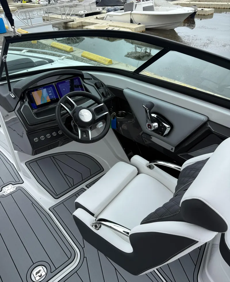 Slide: The Image of 2025 Monterey 238 Super Sport boat interior with modern dashboard and steering wheel. - 9