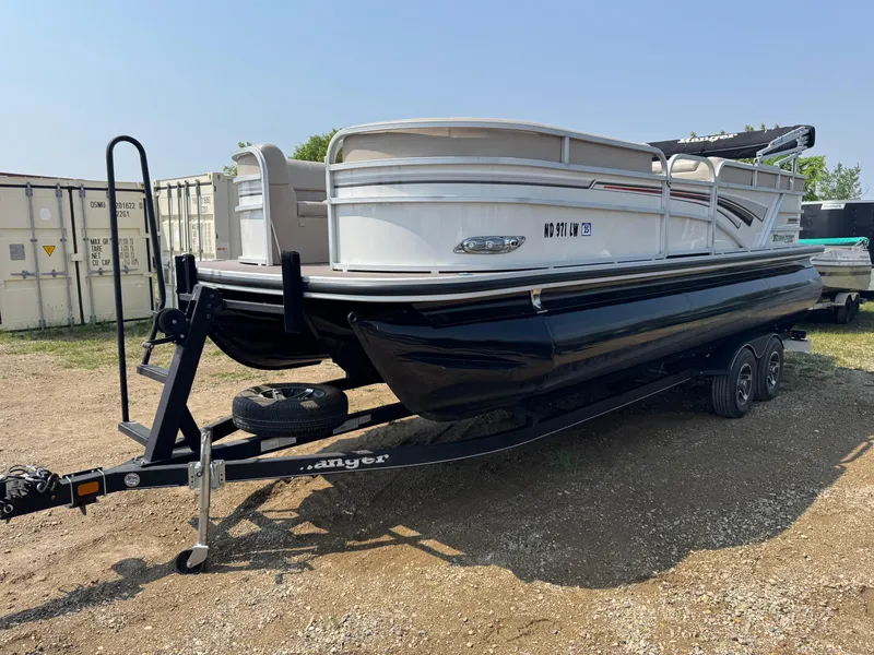 Slide: The Image of 2020 Ranger Reata 223C pontoon boat on trailer, parked outdoors. - 1
