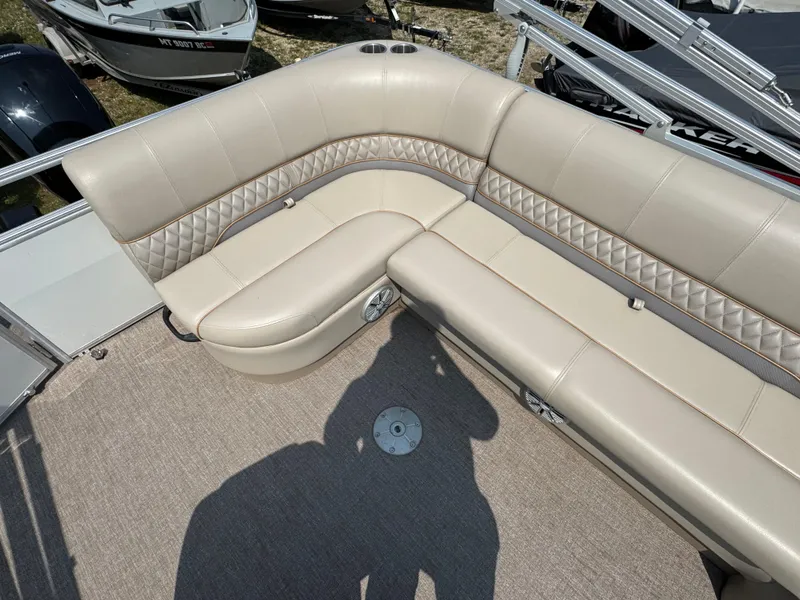 Slide: The Image of 2020 Ranger Reata 223C boat interior with beige cushioned seating and carpeted floor. - 10