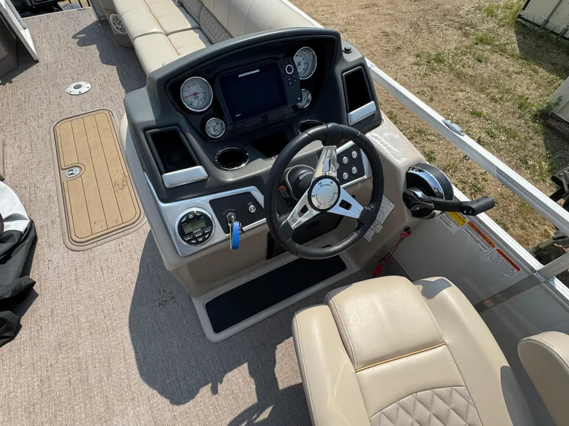Slide: The Image of 2020 Ranger Reata 223C boat dashboard with steering wheel and control panel. - 13
