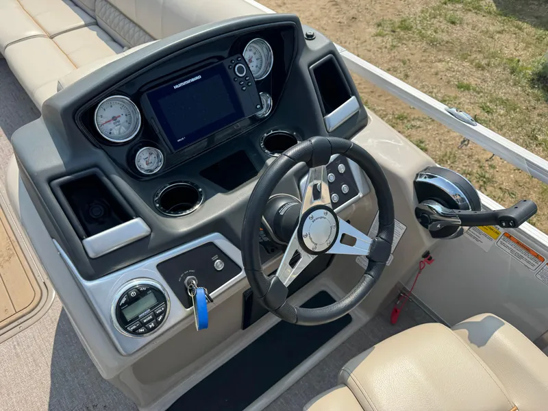 Slide: The Image of 2020 Ranger Reata 223C boat dashboard with steering wheel and control panel. - 15