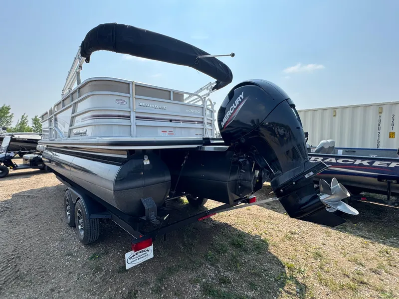 Slide: The Image of 2020 Ranger Reata 223C pontoon boat with Mercury outboard motor on a trailer. - 4