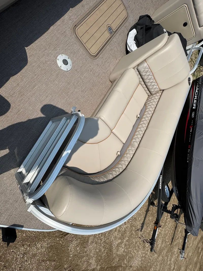 Slide: The Image of 2020 Ranger Reata 223C boat interior with beige seating and carpeted floor. - 6