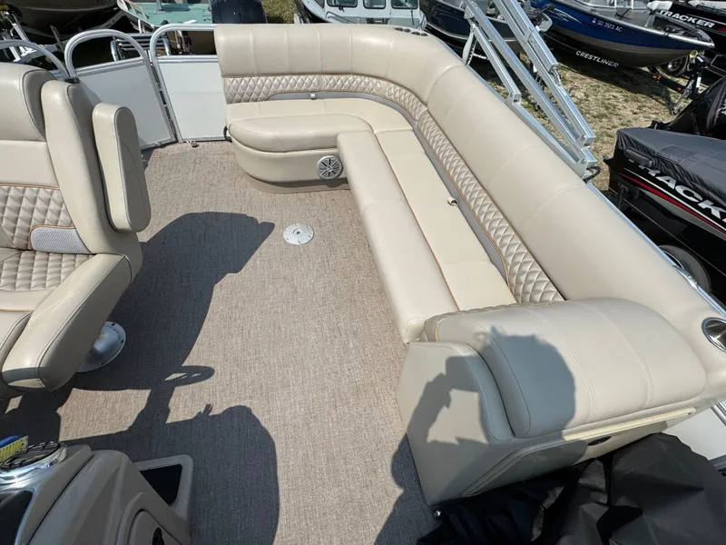 Slide: The Image of 2020 Ranger Reata 223C boat interior with beige seating and carpeted floor. - 7