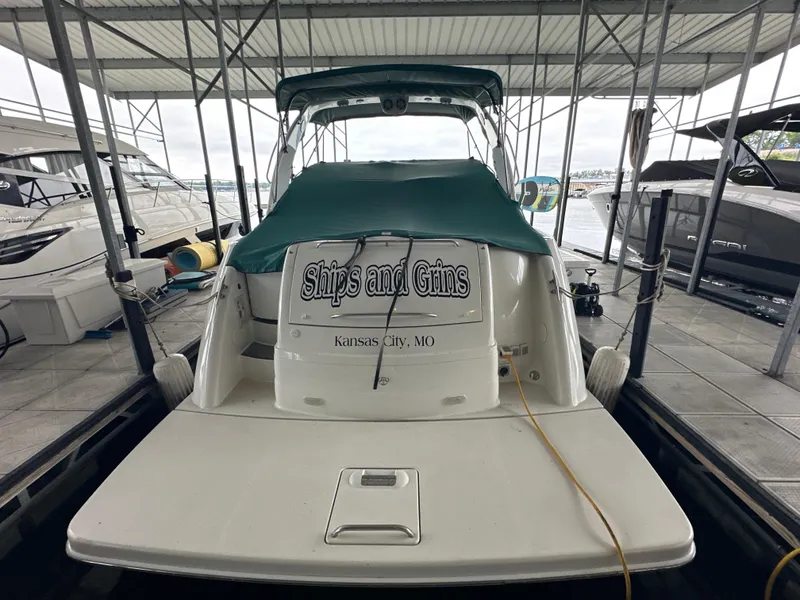 Slide: The Image of 2000 Formula 40 PC boat docked, covered with green tarp, "Ships and Gins" text visible. - 12