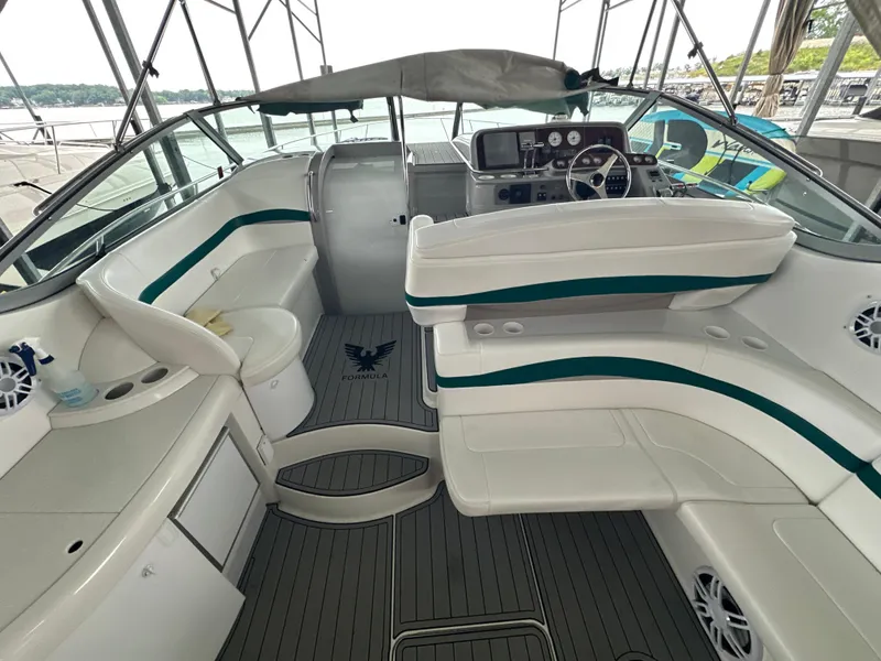 Slide: The Image of Interior of 2000 Formula 40 PC boat with white seating and steering console. - 14