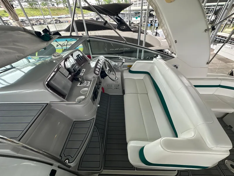 Slide: The Image of Interior of a 2000 Formula 40 PC yacht with white seating and modern dashboard. - 16
