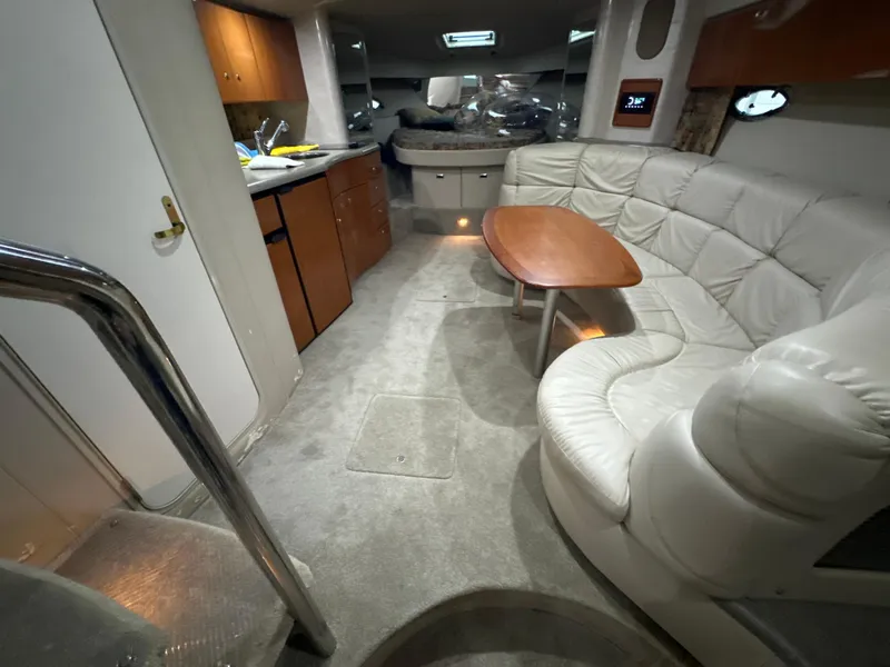 Slide: The Image of Interior of a 2000 Formula 40 PC yacht with a cozy seating area and kitchenette. - 28