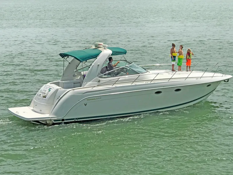 Slide: The Image of 2000 Formula 40 PC yacht cruising with passengers on deck in open water. - 3