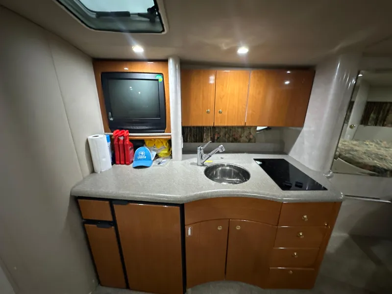 Slide: The Image of Interior of 2000 Formula 40 PC yacht kitchen with sink, stove, and cabinets. - 36