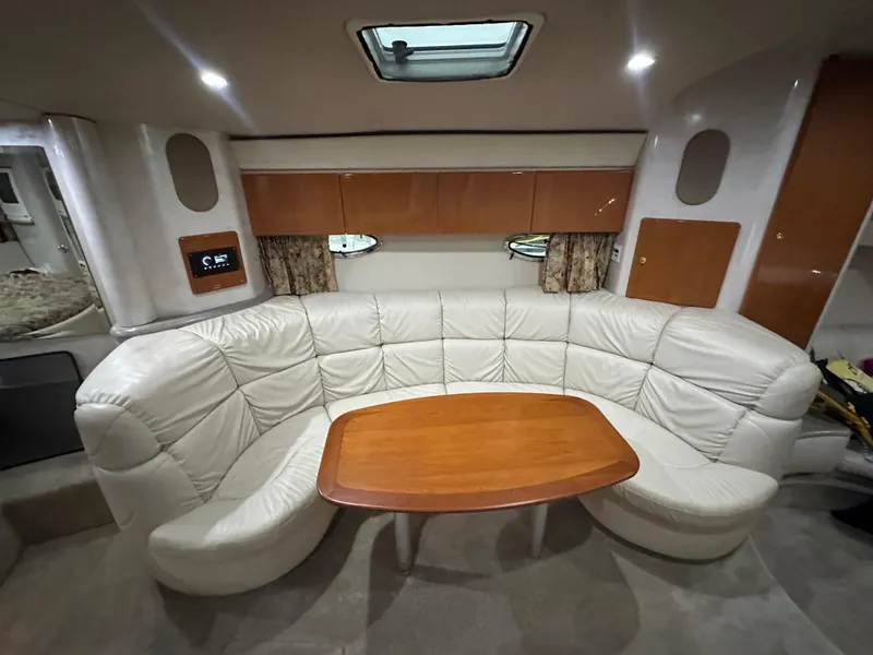Slide: The Image of Interior of 2000 Formula 40 PC yacht with white leather seating and wooden table. - 39