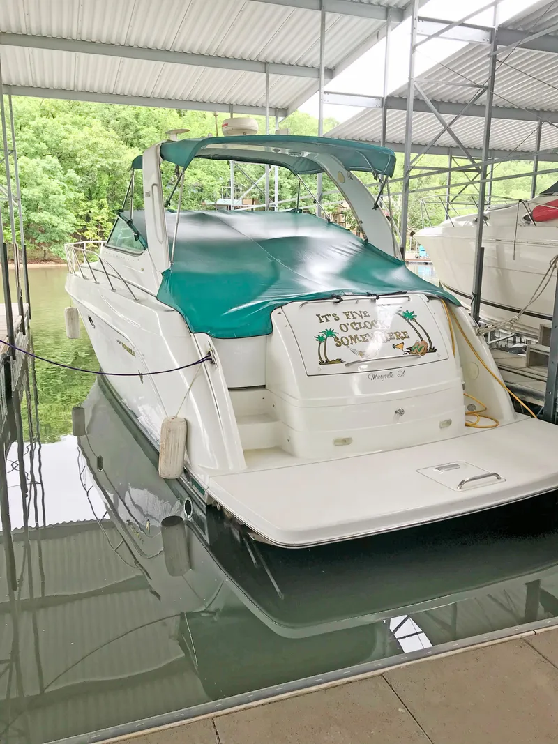 Slide: The Image of 2000 Formula 40 PC boat docked under a covered marina with green canopy. - 5