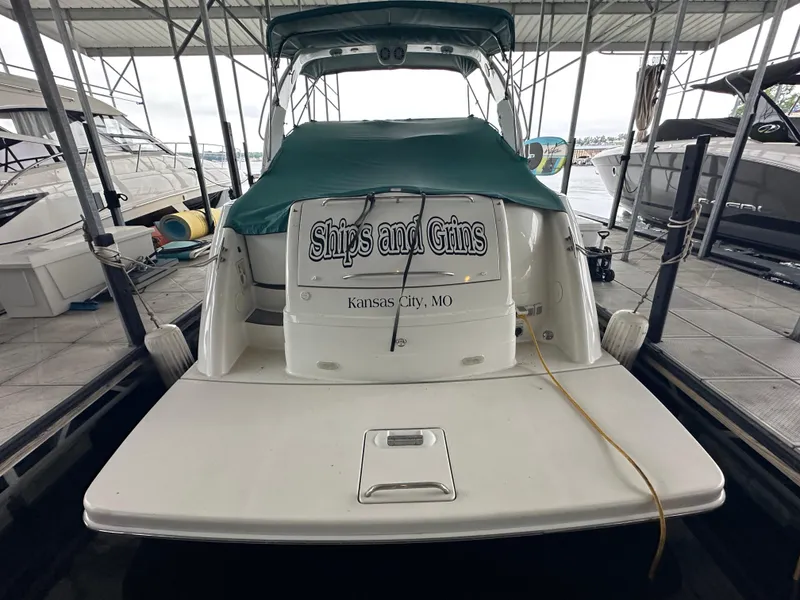 Slide: The Image of 2000 Formula 40 PC boat docked, covered with green tarp, named "Ships and Gins," Kansas City, MO. - 7