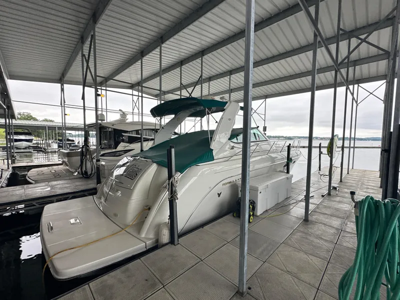 Slide: The Image of 2000 Formula 40 PC yacht docked under covered marina with green canopy. - 8