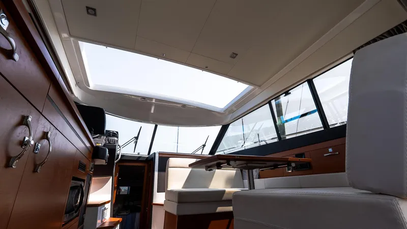 Slide: The Image of Interior of 2018 Jeanneau NC11 yacht, featuring modern seating and panoramic windows. - 16