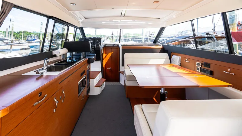 Slide: The Image of Interior of 2018 Jeanneau NC11 yacht with modern kitchen and dining area. - 17