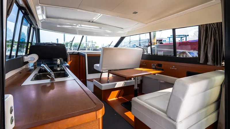 Slide: The Image of Interior of 2018 Jeanneau NC11 yacht with modern seating and kitchen area. - 21