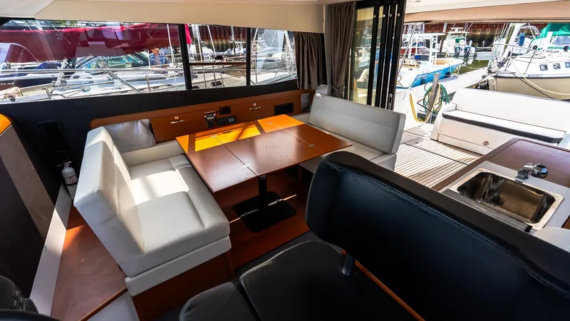 Slide: The Image of Interior of 2018 Jeanneau NC11 yacht with seating, table, and kitchenette. - 26