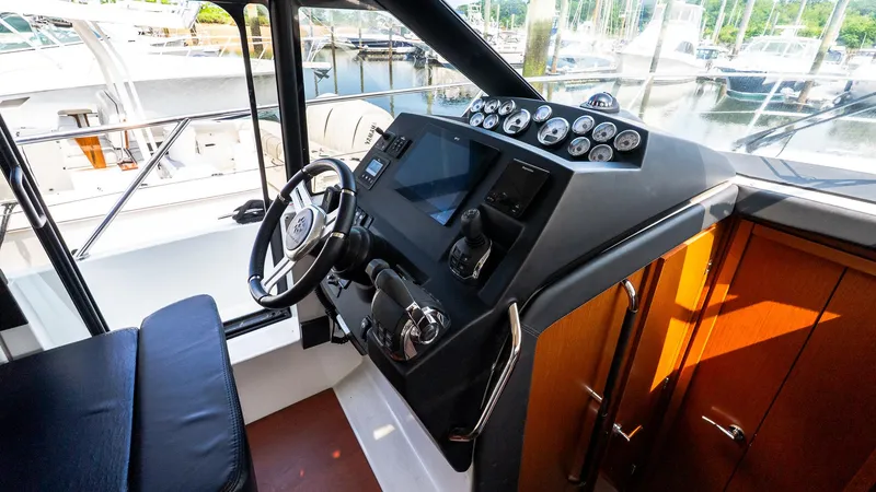 Slide: The Image of 2018 Jeanneau NC11 helm with modern controls and sleek design. - 29