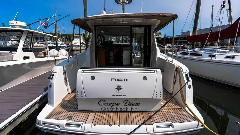 Slide: The Image of 2018 Jeanneau NC11 yacht docked, rear view, named "Carpe Diem," Great Neck, NY. - 3