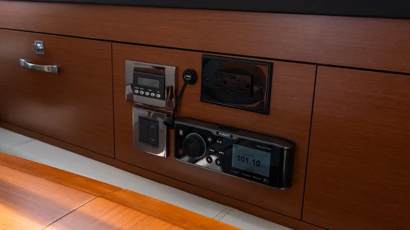 Slide: The Image of Control panel on 2018 Jeanneau NC11 yacht with wood finish and electronic displays. - 31