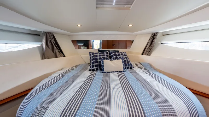 Slide: The Image of 2018 Jeanneau NC11 cabin with striped bedding and modern interior design. - 32