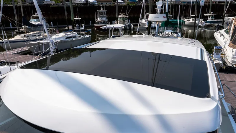Slide: The Image of 2018 Jeanneau NC11 yacht docked at marina, showcasing sleek design and sunroof. - 37
