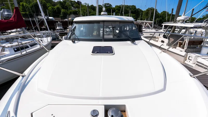 Slide: The Image of 2018 Jeanneau NC11 yacht docked at marina, showcasing sleek design and spacious deck. - 38