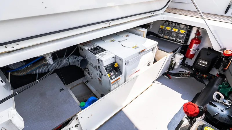 Slide: The Image of Engine compartment of 2018 Jeanneau NC11 boat with generator and fire extinguisher. - 6