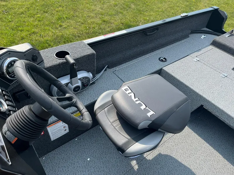 Slide: The Image of 2026 Lund 1650 Rebel XL SS boat interior with steering wheel and seat. - 13