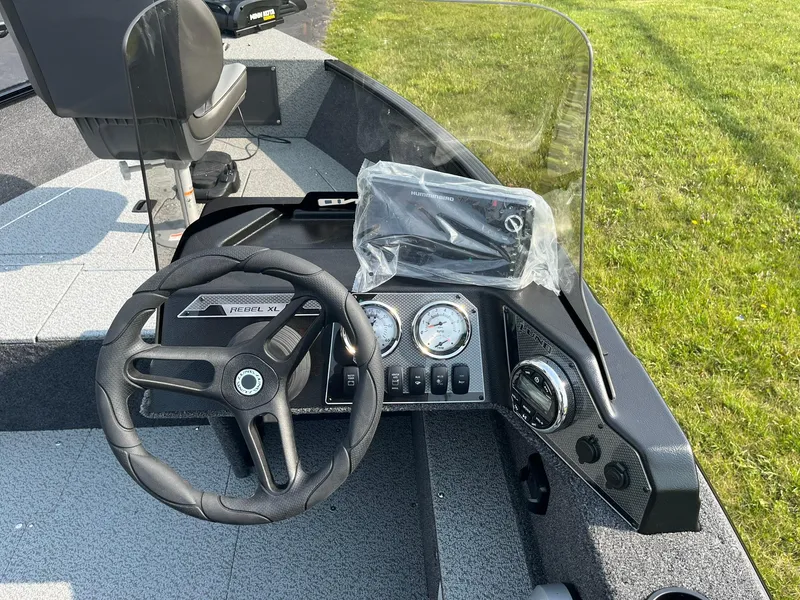 Slide: The Image of 2026 Lund 1650 Rebel XL SS boat dashboard with steering wheel and gauges. - 15