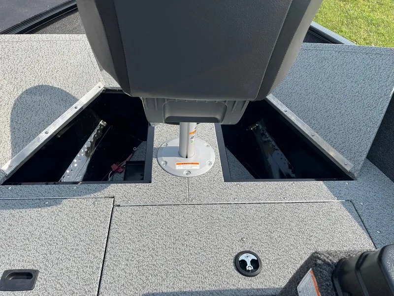 Slide: The Image of 2026 Lund 1650 Rebel XL SS boat interior with storage compartments and seating. - 16