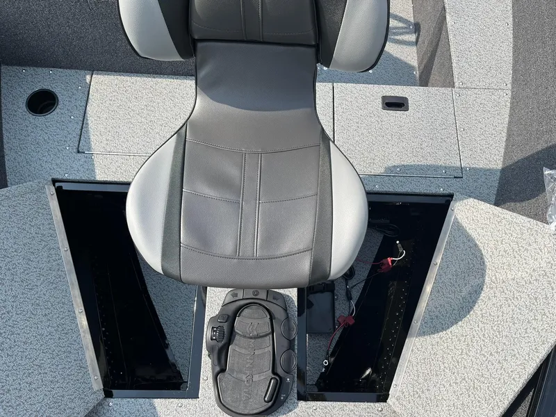 Slide: The Image of 2026 Lund 1650 Rebel XL SS boat interior with gray seat and storage compartments. - 17